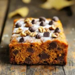 - 1 cup canned pumpkin puree - 1/2 cup vegetable oil - 1 cup brown sugar, packed - 1/2 cup granulated sugar The base of our cake starts with these essential ingredients. Canned pumpkin puree gives the cake its moistness and flavor. Vegetable oil keeps it tender and light. The brown sugar adds depth, while granulated sugar brings sweetness. - 2 large eggs - 1 teaspoon vanilla extract - 1 1/2 cups all-purpose flour - 1 teaspoon baking soda - 1 teaspoon baking powder Next, we need eggs for binding and richness. The vanilla extract boosts the cake's aroma and taste. All-purpose flour provides structure. Baking soda and baking powder help the cake rise and become fluffy. - 1 teaspoon ground cinnamon - 1/2 teaspoon ground nutmeg - 1/4 teaspoon ground ginger - 1/2 teaspoon salt - 1 cup chocolate chips (semi-sweet or dark) - 1/2 cup chopped walnuts (optional) Spices like cinnamon, nutmeg, and ginger add warmth and depth to the cake. Salt balances flavors. Chocolate chips bring sweetness and richness. You can add walnuts for extra crunch and flavor, but they are optional. Each ingredient plays a key role in making this cake delightful. - Preheat oven to 350°F (175°C). - Prepare baking pan with grease or parchment. First, you need to get your oven ready. Set it to 350°F. This keeps your cake from being too dense. Next, take a 9x13-inch baking pan. Grease it with butter or use parchment paper. This helps the cake come out easily after baking. - Mix pumpkin puree, oils, and sugars. - Add eggs and vanilla. In a big bowl, mix the pumpkin puree and oils. Add both sugars. Stir until it looks smooth. Then, crack in the eggs, one by one. Mix well after each egg. Finally, pour in the vanilla extract. This adds a lovely flavor. - Sift and mix dry ingredients separately. - Gently fold dry and wet mixes. - Stir in chocolate chips and walnuts. Now, take another bowl. Sift together the flour, baking soda, baking powder, and spices. This makes the cake light. Gradually add the dry mix to your wet ingredients. Use a spatula to fold them together gently. Don’t overmix! It should look thick but smooth. Then add the chocolate chips and walnuts if you want. Stir until everything is evenly spread out. - Pour batter into the pan. - Bake and check doneness. Pour your batter into the prepared pan. Spread it evenly with a spatula. Now, place it in the oven. Bake for about 30 to 35 minutes. Check if it’s done by poking the center with a toothpick. If it comes out clean, it’s ready. - Cool in the pan then on a wire rack. Once baked, let the cake cool in the pan for about 10 minutes. This helps it set. After that, carefully move the cake to a wire rack. Let it cool completely before slicing. Enjoy the delightful aroma as it cools! To get the best texture, do not overmix the batter. Overmixing makes the cake dense. Mix just until you see no dry flour. This keeps it light and fluffy. Humidity can change how your batter acts. If it's humid, add a bit more flour. This helps keep the cake from being too wet. Spices can really boost the taste. Try adding more cinnamon or a pinch of cloves. These spices give a warm flavor that pairs well with pumpkin. You can choose different types of chocolate chips. Semi-sweet chips give a sweet touch, while dark chips add richness. You can mix both for a treat! For a nice finish, dust the cake with powdered sugar. This adds a sweet touch and looks great. You can also top the cake with whipped cream. A sprinkle of cinnamon on top makes it even better! {{image_2}} You can make this cake healthier with a few simple swaps. Using whole wheat flour adds fiber and nutrients. It gives a heartier texture. You can also cut down on sugar. Try using half the granulated sugar. The pumpkin puree adds natural sweetness, so you may not miss it. Want to change the flavor? Adding spices can really elevate your cake. Try using allspice or cardamom for a warm taste. You can also toss in dried fruits like raisins. They add a chewy texture and a sweet burst. If you're vegan, you can still enjoy this cake. Substitute the eggs with flaxseed meal or applesauce. For gluten-free options, swap the all-purpose flour for almond or coconut flour. Just remember to adjust baking times, as gluten-free flours can behave differently. To store your pumpkin chocolate chip snack cake at room temperature, place it in an airtight container. This keeps the cake fresh for about three days. If you do not have a container, you can cover the cake with plastic wrap. This helps retain moisture and prevents it from drying out. For long-term storage, consider freezing the cake. Cut it into slices and wrap each piece tightly in plastic wrap. Then place the wrapped slices in a freezer bag. This way, you can enjoy a piece later without losing flavor. When you are ready to enjoy the cake, thaw it in the fridge overnight. If you're in a hurry, you can leave it on the counter for a few hours. Just make sure it’s completely thawed before serving. Yes, you can use fresh pumpkin. Just cook and puree it first. Fresh pumpkin may add a different taste. It can also change the moisture level. If using fresh, aim for about 1 cup of pureed pumpkin. The pumpkin chocolate chip cake can last for up to five days. Store it in an airtight container at room temperature. If you want it to last longer, keep it in the fridge. This way, it can stay fresh for about a week. Yes, you can make this cake a day ahead. Just bake and let it cool completely. Cover it well and store it in the fridge. This will help the flavors blend nicely. You can use applesauce or mashed bananas as an egg substitute. Use 1/4 cup for each egg. You can also try flaxseed meal mixed with water. Combine 1 tablespoon of flaxseed with 2.5 tablespoons of water for one egg. Yes, it can fit many diets with some changes. For gluten-free, use a gluten-free flour blend. For vegan diets, use egg substitutes as mentioned. Check the chocolate chips for dairy-free options if needed. In this blog post, we covered how to make a delicious pumpkin chocolate chip cake. We discussed essential and optional ingredients, detailed step-by-step instructions, and shared tips for perfecting the texture and flavor. You learned about different baking variations and storage options. Remember, baking can be fun and flexible. Don't hesitate to adjust the recipe to suit your taste. Enjoy every bite of your homemade creation!
