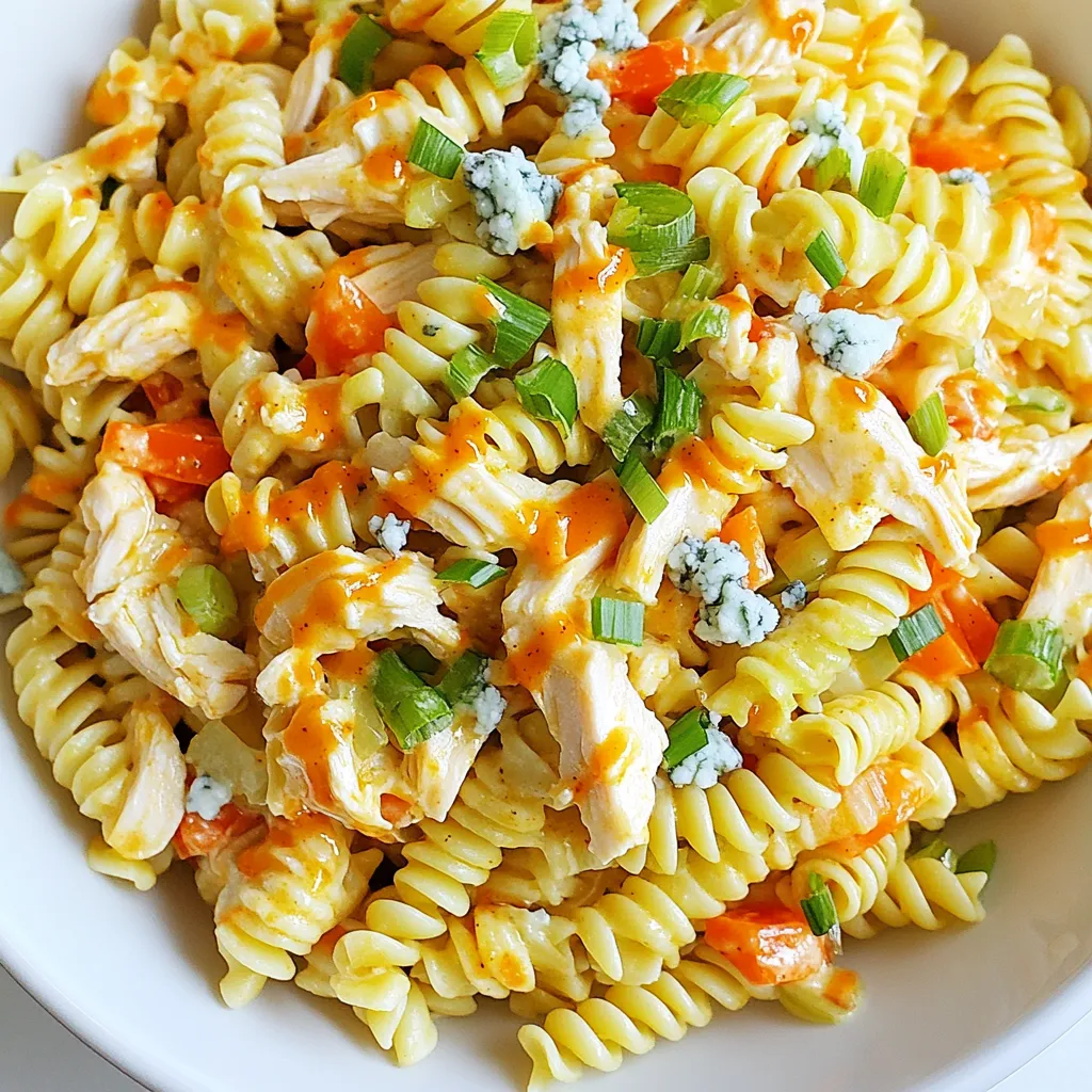 - 2 cups rotini or fusilli pasta - 1 cup cooked chicken, shredded - 1/2 cup celery, finely chopped - 1/2 cup red bell pepper, diced - 1/2 cup carrot, grated - 1/2 cup blue cheese crumbles - 1/4 cup green onions, sliced - 1/2 cup ranch dressing - 1/4 cup buffalo sauce - Salt and pepper to taste The main ingredients make this dish pop. The rotini or fusilli pasta provides a great base. I love using rotini because it holds sauce well. You need about two cups. Next, you need cooked chicken. I suggest using one cup of shredded chicken. You can use leftover chicken or grab a rotisserie chicken. It saves time and adds flavor. For crunch, add half a cup of finely chopped celery. It gives a nice bite. Then, mix in half a cup of diced red bell pepper for sweetness. Don’t forget the grated carrot! Half a cup adds color and a bit of sweetness. Blue cheese crumbles bring a creamy, tangy flavor. Use half a cup for the best taste. Green onions add a fresh taste. Slice a quarter cup and toss them in. Finally, we’ll use ranch dressing and buffalo sauce. A half-cup of ranch and a quarter-cup of buffalo sauce balance the flavors perfectly. Season with salt and pepper to taste, and you're set! - Large pot for boiling pasta - Mixing bowls - Whisk - Measuring cups and spoons To make this dish, gather a few handy tools. A large pot is a must for boiling the pasta. You need mixing bowls to combine all the ingredients. A whisk helps blend the ranch and buffalo sauces smoothly. Keep measuring cups and spoons handy for precise amounts. These tools make the cooking process easy and fun! {{ingredient_image_1}} To cook the pasta, start with a large pot. Fill it with water and add salt. Bring the water to a rolling boil. Then add 2 cups of rotini or fusilli pasta. Cook according to the package instructions until it is al dente, which means it should be firm but not hard. This usually takes about 8 to 10 minutes. Drain the pasta in a colander and let it cool for a few minutes. Cooling is key, as it helps the pasta absorb the flavors later on. While the pasta cooks, it’s time to prepare the chicken. If you have leftover chicken, shred it into bite-sized pieces. This makes it easy to mix later. If you don’t have leftover chicken, you can use store-bought rotisserie chicken. It’s quick and tasty. Just remove the skin and shred the meat with your hands or a fork. Now, let’s combine the chicken with the veggies. In a large mixing bowl, add the shredded chicken. Then, add 1/2 cup of finely chopped celery, 1/2 cup of diced red bell pepper, 1/2 cup of grated carrot, 1/2 cup of blue cheese crumbles, and 1/4 cup of sliced green onions. Stir these ingredients together gently. Next, it’s time to make the dressing. In a small bowl, whisk together 1/2 cup of ranch dressing and 1/4 cup of buffalo sauce. Mix until they are fully combined. Taste it and add salt and pepper if needed. Now, add the cooled pasta to the bowl with the chicken and veggies. Pour the dressing mixture over everything. Toss gently until all the ingredients are well mixed and coated with the sauce. Cover the bowl and place it in the refrigerator. Let it chill for at least 30 minutes. This chilling time helps the flavors blend and enhances the taste. To make your Buffalo Chicken Pasta Salad taste just right, start with salt and pepper. Add a little salt first, then mix well. Taste it before you add more. You want to find the perfect balance. If you want more tang, add extra ranch or buffalo sauce. A splash of lemon juice can brighten up the flavors too. When serving this salad, think about garnishes. Blue cheese crumbles add a rich flavor. You can also slice green onions on top for a fresh touch. Serve it chilled for the best experience. The coolness helps the flavors blend nicely. Using rotisserie chicken is a great time-saver. It cuts down on prep time a lot. You can also chop veggies the day before. This way, you can just mix everything together when you’re ready. Enjoy your tasty meal with less fuss! Pro Tips Use Rotisserie Chicken: For a quicker prep time, consider using store-bought rotisserie chicken instead of cooking your own. Chill for Flavor: Allowing the salad to chill in the refrigerator for at least 30 minutes helps the flavors meld beautifully. Adjust Heat Level: If you prefer a milder salad, reduce the amount of buffalo sauce or opt for a milder variety. Fresh Ingredients: Using fresh vegetables and herbs will enhance the overall flavor and texture of the pasta salad. {{image_2}} You can easily swap dressings in this salad. Instead of ranch, try blue cheese dressing for a richer taste. A vinaigrette adds a light touch. For spices, use smoked paprika or garlic powder. These give a warm flavor twist. When it comes to vegetables, the options are endless. Try adding cherry tomatoes for sweetness. Spinach or arugula can add a fresh crunch. You can also throw in corn for a bit of sweetness and color. Just keep the balance in mind! If you want to change the chicken style, grilling or baking works great. Grilled chicken adds a smoky flavor, while baked chicken keeps it juicy. You can even use shredded buffalo chicken for an extra kick. For a vegetarian option, swap chicken for chickpeas or black beans. They add protein and fiber. Another tasty choice is to use tofu. Just marinate it in buffalo sauce before cooking for flavor. To make this salad gluten-free, use gluten-free pasta. You can find many options made from rice or quinoa. These will hold up well with other ingredients. For dairy-free options, skip the blue cheese. Use a dairy-free dressing or a homemade cashew cream. Cashew cream is creamy and rich, making it a great substitute. To keep your Buffalo Chicken Pasta Salad fresh, store it in an airtight container. This helps keep the flavors locked in. Place the container in the refrigerator. It will stay good for about 3 to 5 days. When you store leftovers, try to add the dressing only to the portion you will eat right away. This keeps the pasta from getting soggy. If you have extra dressing, store it in a separate container. I do not recommend freezing Buffalo Chicken Pasta Salad. The pasta and veggies may become mushy when thawed. Freezing can also change the texture of the blue cheese. If you decide to freeze it, place the salad in a freezer-safe container. Make sure to leave some space for expansion. To defrost, move the salad to the fridge overnight. When you are ready to eat, stir it well after defrosting. You may want to add a bit of fresh dressing to boost the flavors again. Enjoy! You can store Buffalo Chicken Pasta Salad in the fridge for about 3 to 5 days. Make sure to keep it in an airtight container to keep it fresh. After a few days, check for any changes in smell or texture. When in doubt, throw it out! Yes, you can use whole wheat pasta instead of regular pasta. Whole wheat adds more fiber and gives a nutty taste. It may also change the texture slightly, making it a bit firmer. Cook it the same way as regular pasta for the best results. Absolutely! Adding more veggies can boost flavor and nutrition. Here are some great options: - Cherry tomatoes for a sweet bite - Spinach or kale for greens - Cucumbers for crunch - Avocado for creaminess Feel free to mix and match based on your taste! Buffalo Chicken Pasta Salad pairs well with many sides. Here are a few ideas: - Fresh fruit salad for a sweet contrast - Garlic bread for a crispy touch - A light green salad for extra greens - Cold drinks like lemonade or iced tea to cool off the spice These pairings make for a delicious meal! Buffalo Chicken Pasta Salad is a tasty dish to make. We covered the main ingredients, like rotini pasta and cooked chicken, plus helpful tools. I shared step-by-step cooking, mixing, and chilling tips. Flavor balance is key, so use salt and pepper wisely. You can swap ingredients for variety and cater to dietary needs. Remember to store leftovers properly for freshness. With these steps, you can create a delicious meal that everyone will enjoy. Enjoy making this fun salad!